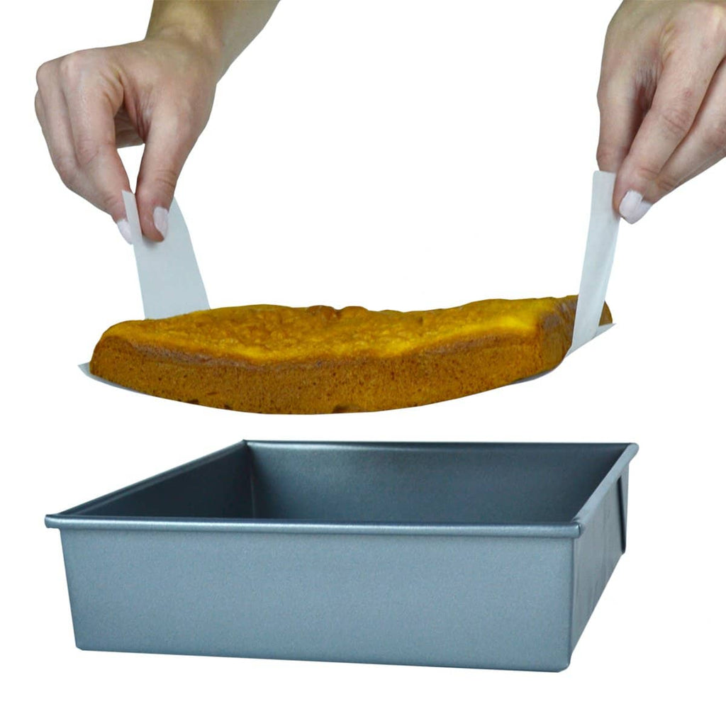8 inch square parchment with lift tabs in use lifting cake